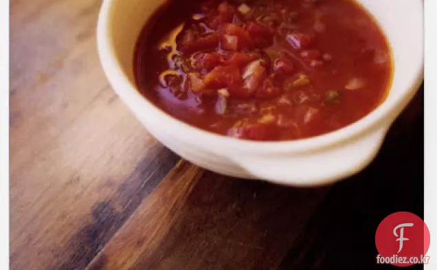 붉은 양파와 실란트로 줄기를 곁들인 토마토 수프